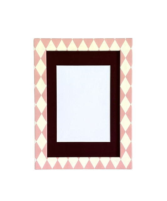 Rectangular picture frame with a pink and white chevron pattern border on a white background