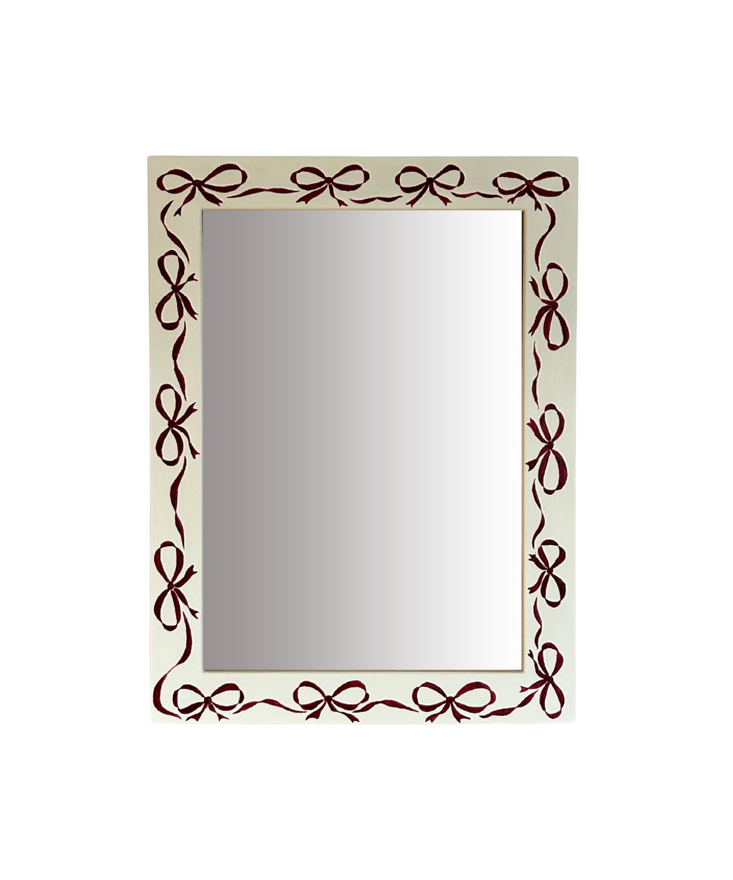 Rectangular mirror with decorative brown bow frame on a white background