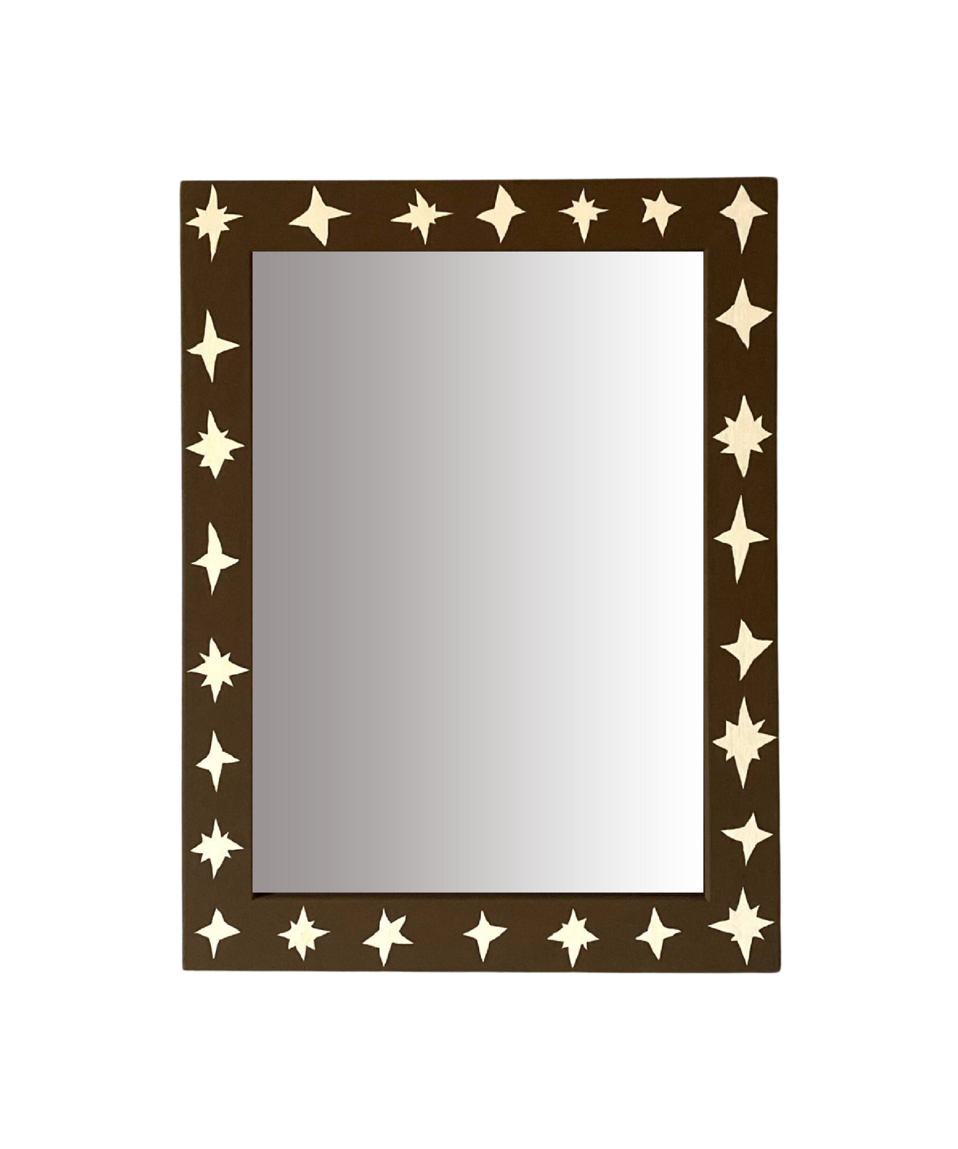 Rectangular mirror with star-shaped cutouts on a brown frame against a white background