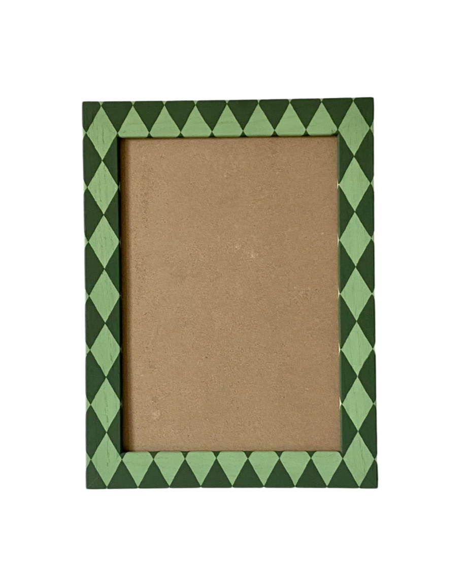 Picture frame with green diamond pattern border on a white background
