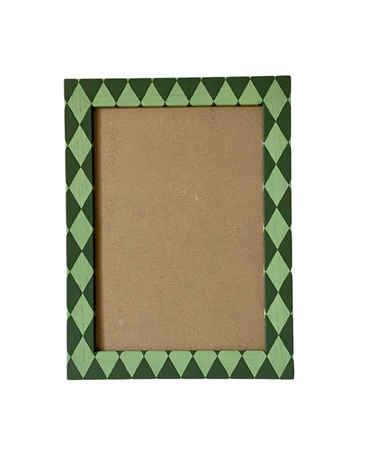 Picture frame with green diamond pattern border on a white background