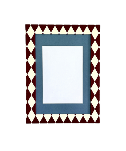 Decorative picture frame with a geometric pattern on a white background