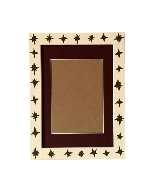 Decorative picture frame with star patterns on a white background
