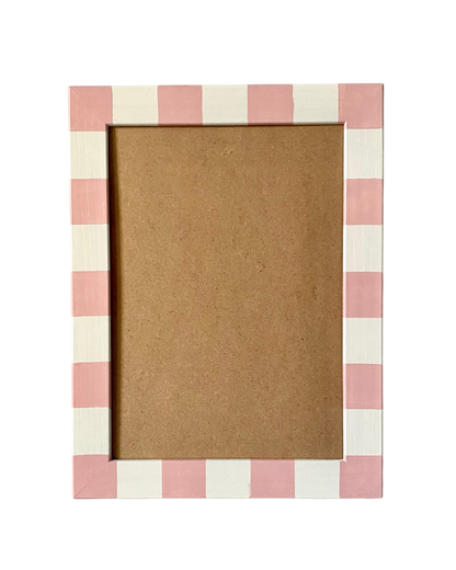 Rectangular photo frame with pink and white checkered border on a white background